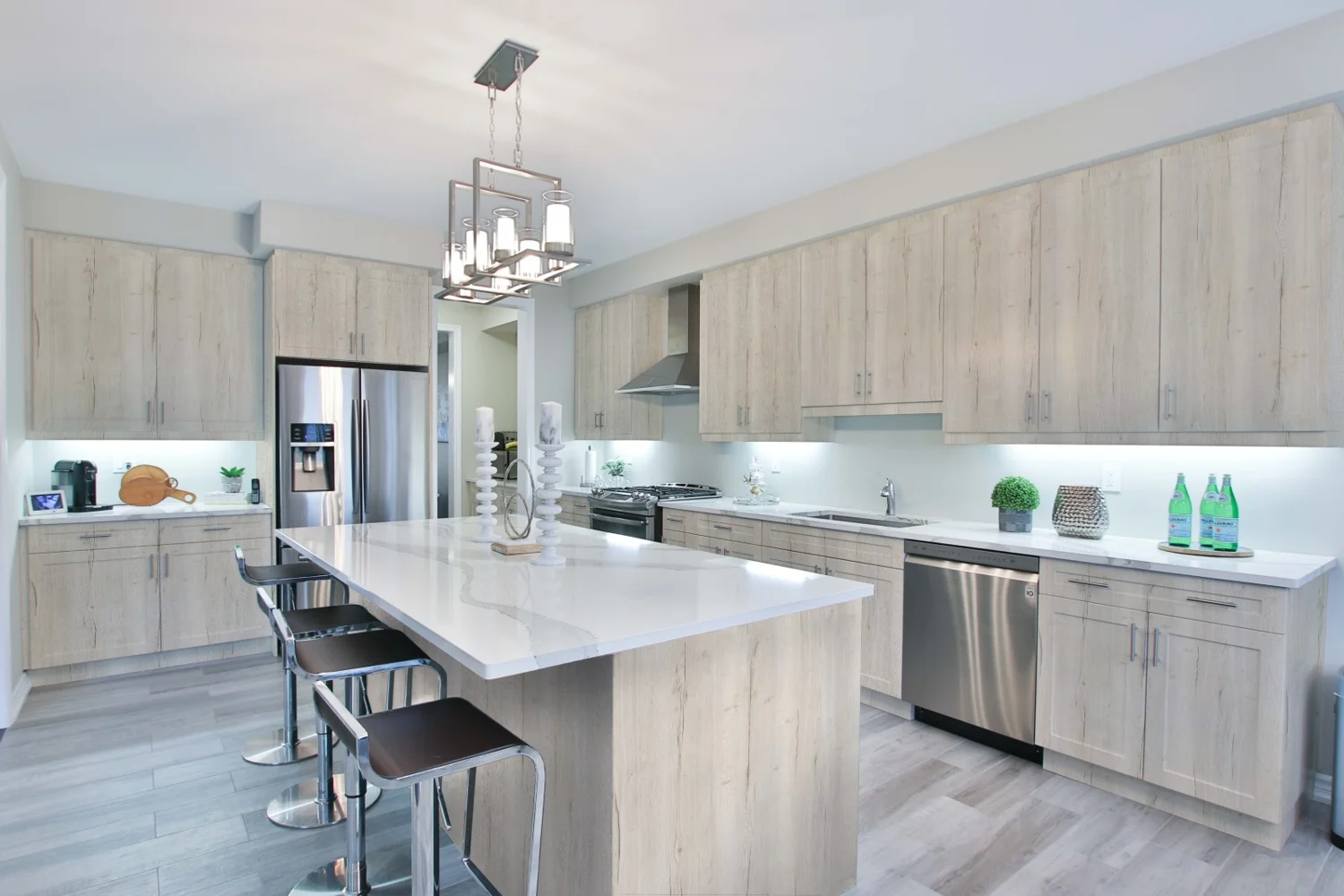 Contemporary kitchen with pale woodgrain cabinetry and a large island